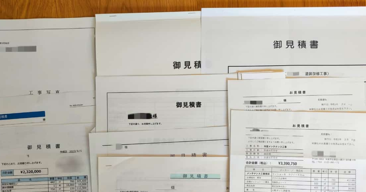実際に受け取った外壁塗装の見積書を机に並べた写真。御見積書と書かれた書類が重なっている